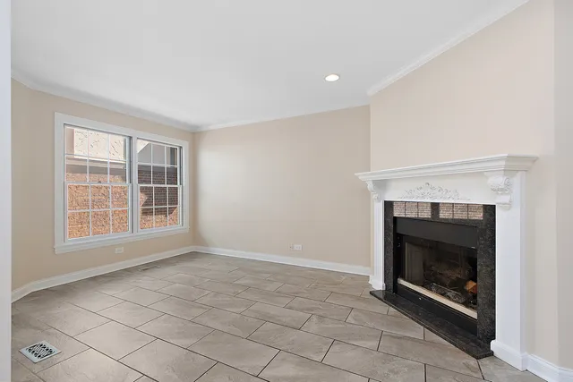 a view of an empty room with a fireplace and a window