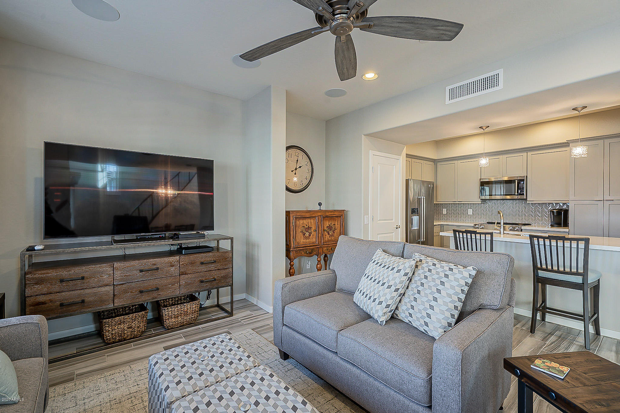 3935 East Rough Rider Road, Unit 1337 Phoenix, AZ 85050 - Photo 15 of 57 a living room with furniture and a flat screen tv