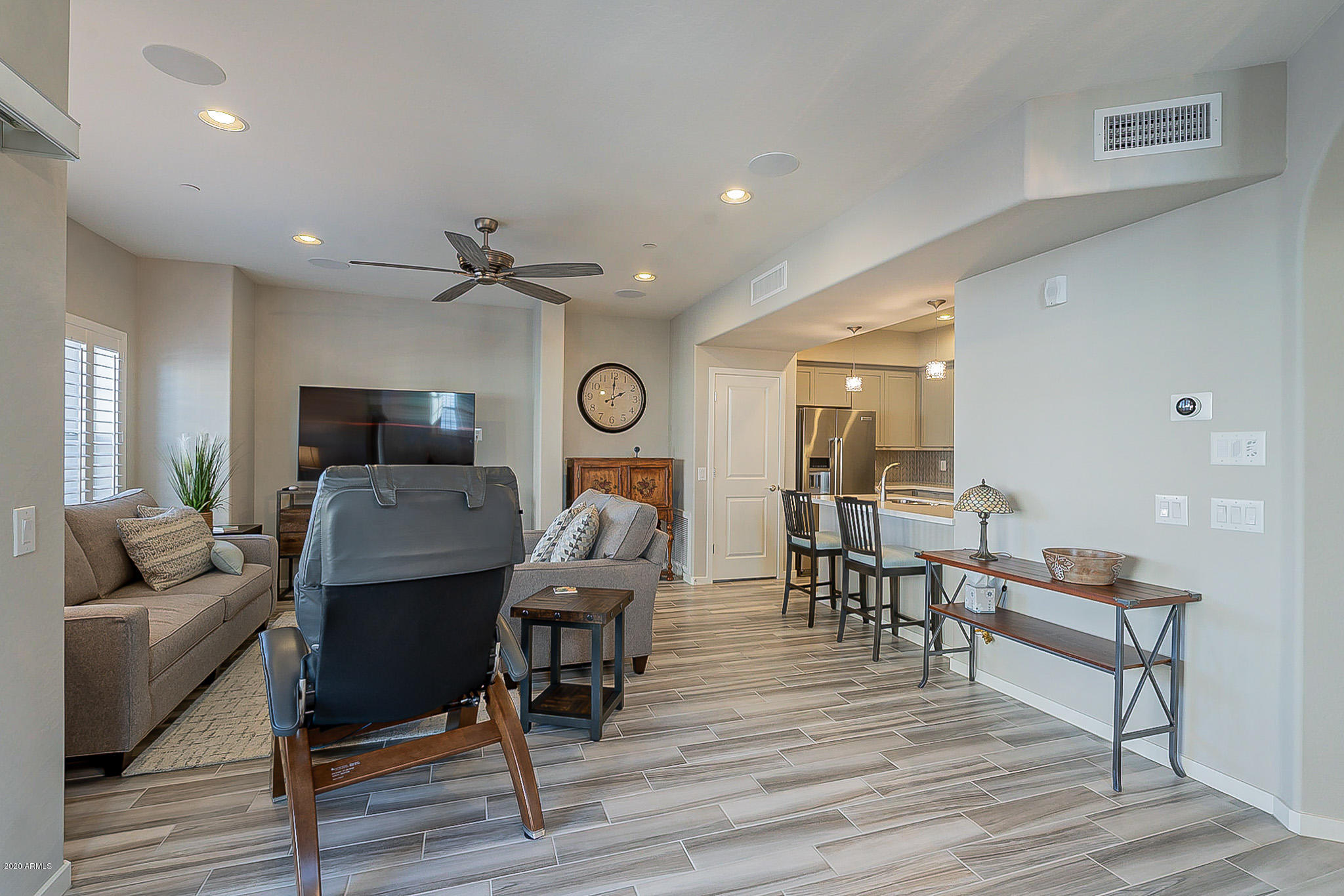 3935 East Rough Rider Road, Unit 1337 Phoenix, AZ 85050 - Photo 16 of 57 a living room with furniture and a wooden floor