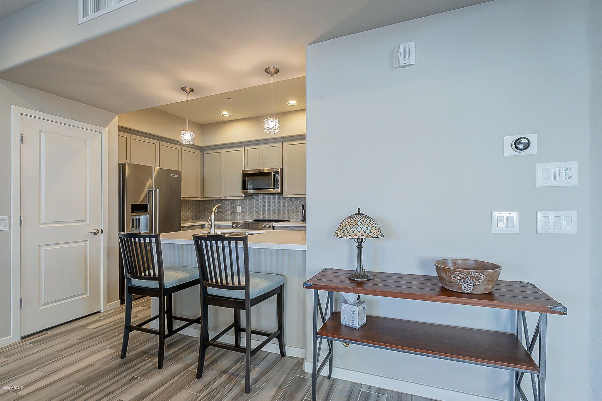 3935 East Rough Rider Road, Unit 1337 Phoenix, AZ 85050 - Photo 17 of 57 a view of a dining room with furniture and wooden floor
