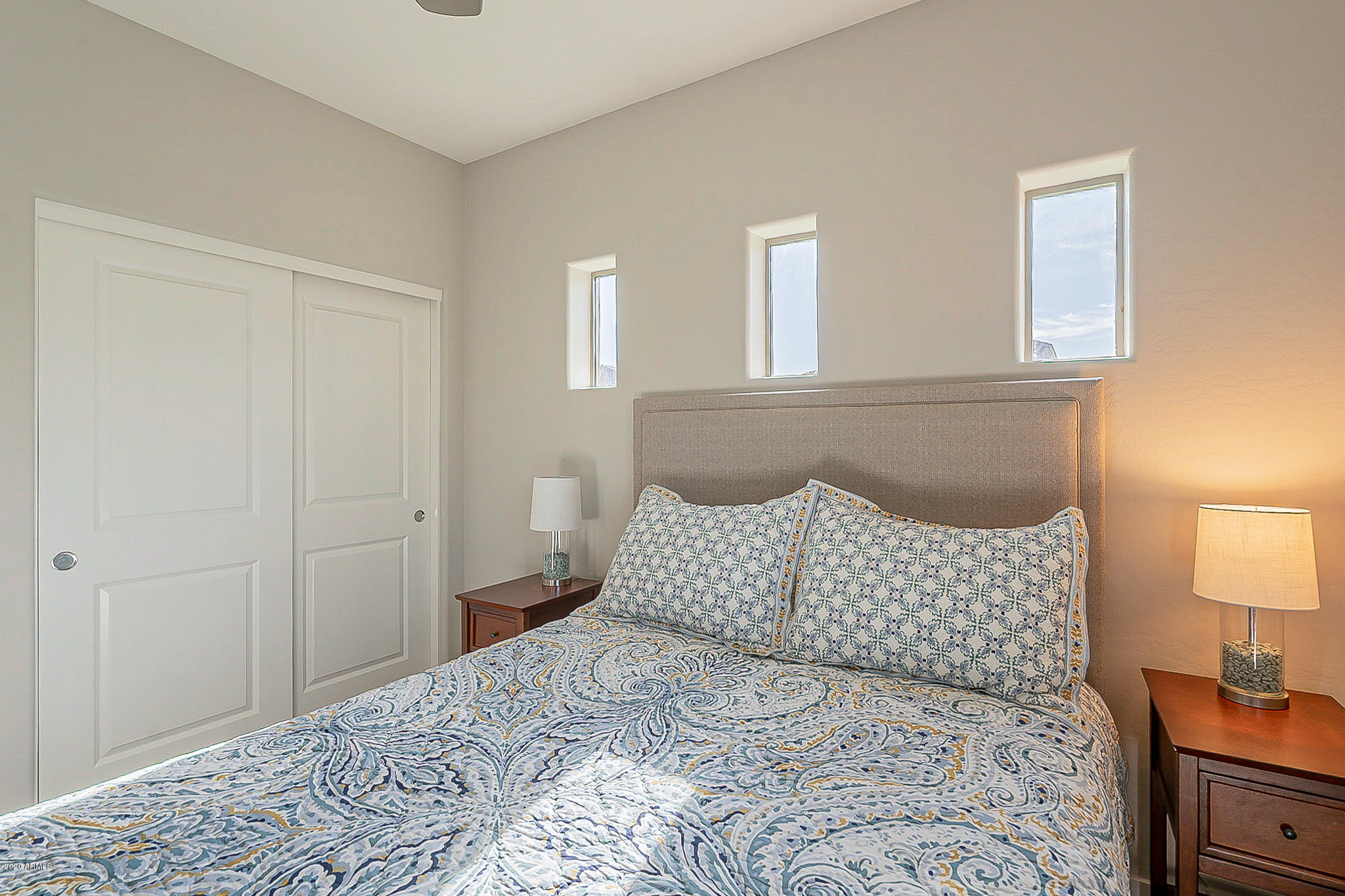 3935 East Rough Rider Road, Unit 1337 Phoenix, AZ 85050 - Photo 24 of 57 a bedroom with a bed and a lamp