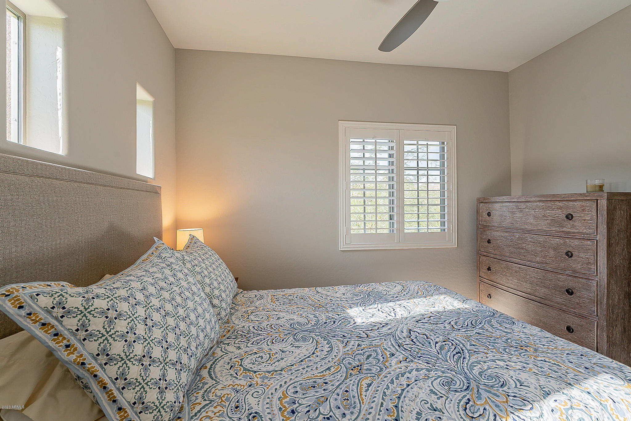 3935 East Rough Rider Road, Unit 1337 Phoenix, AZ 85050 - Photo 25 of 57 a bedroom with a bed and a window