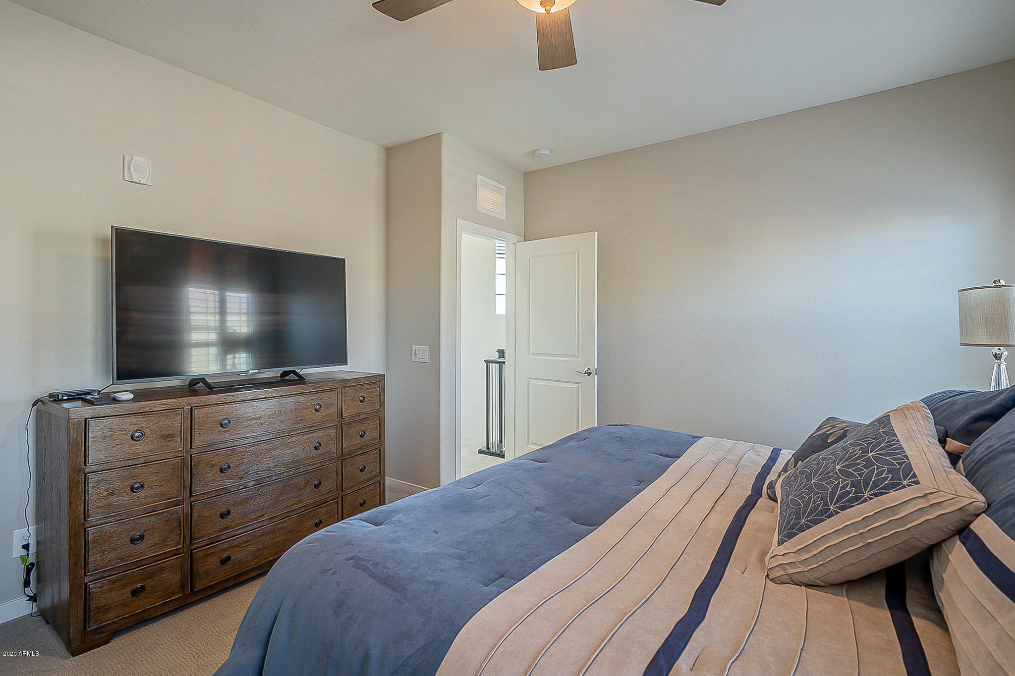 3935 East Rough Rider Road, Unit 1337 Phoenix, AZ 85050 - Photo 38 of 57 a bedroom with a bed and a flat screen tv