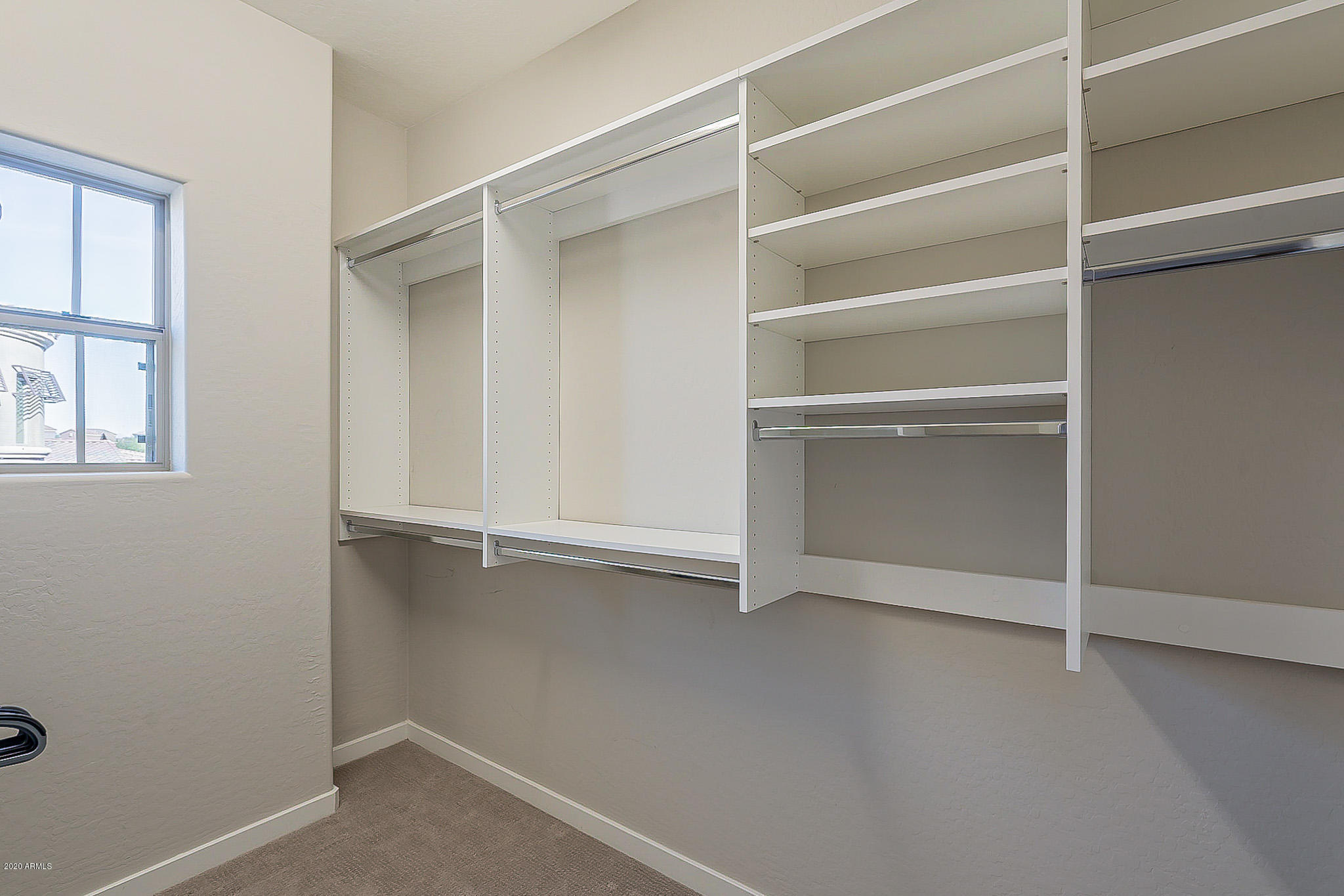 3935 East Rough Rider Road, Unit 1337 Phoenix, AZ 85050 - Photo 39 of 57 a view of an empty walk in closet