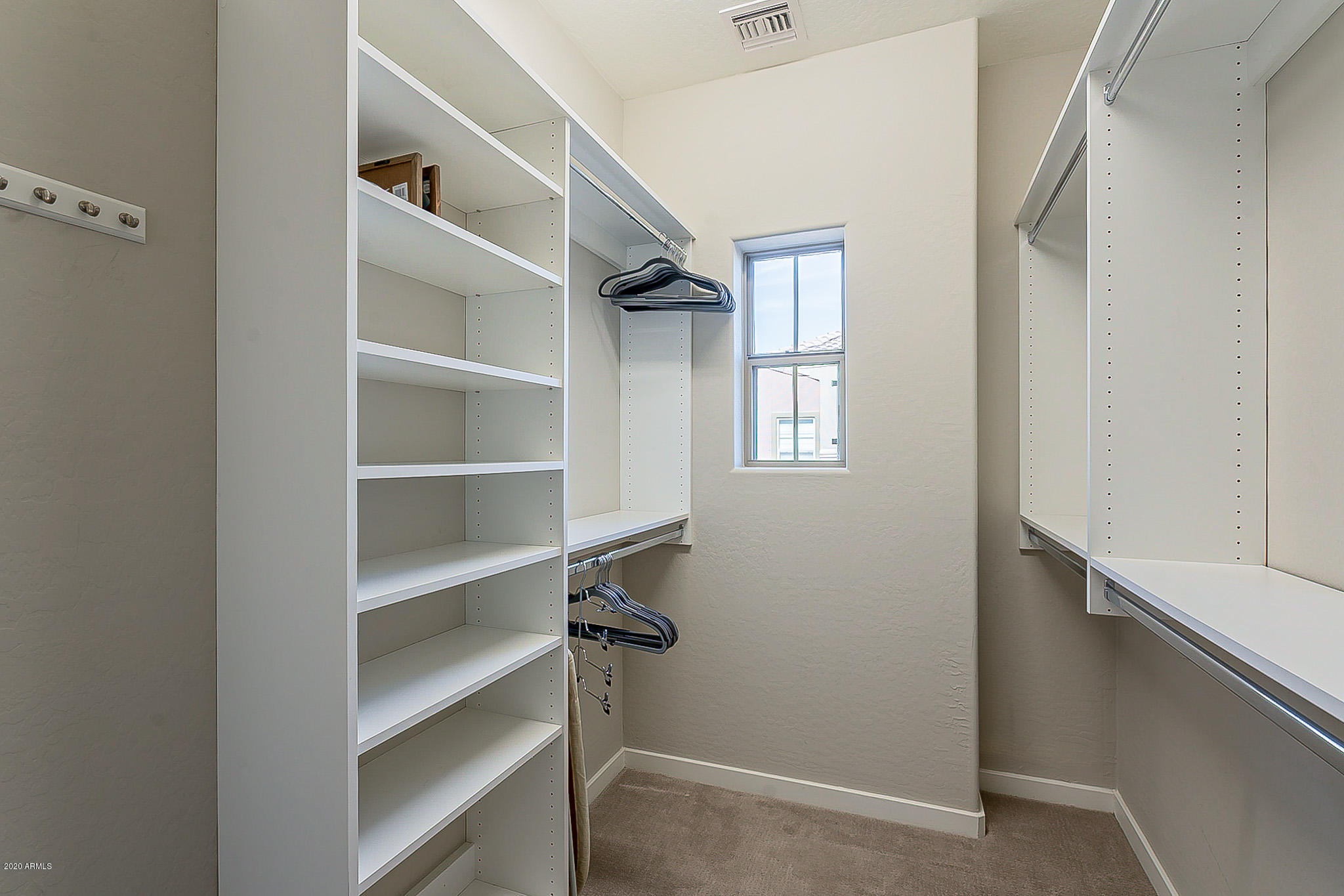3935 East Rough Rider Road, Unit 1337 Phoenix, AZ 85050 - Photo 40 of 57 a view of walk in closet with empty racks