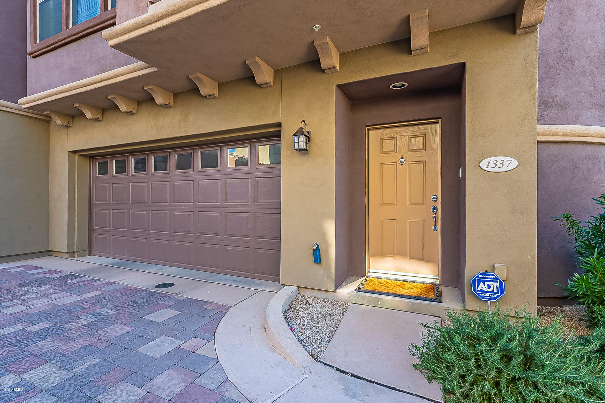 3935 East Rough Rider Road, Unit 1337 Phoenix, AZ 85050 - Photo 4 of 57 a front view of a house with a yard