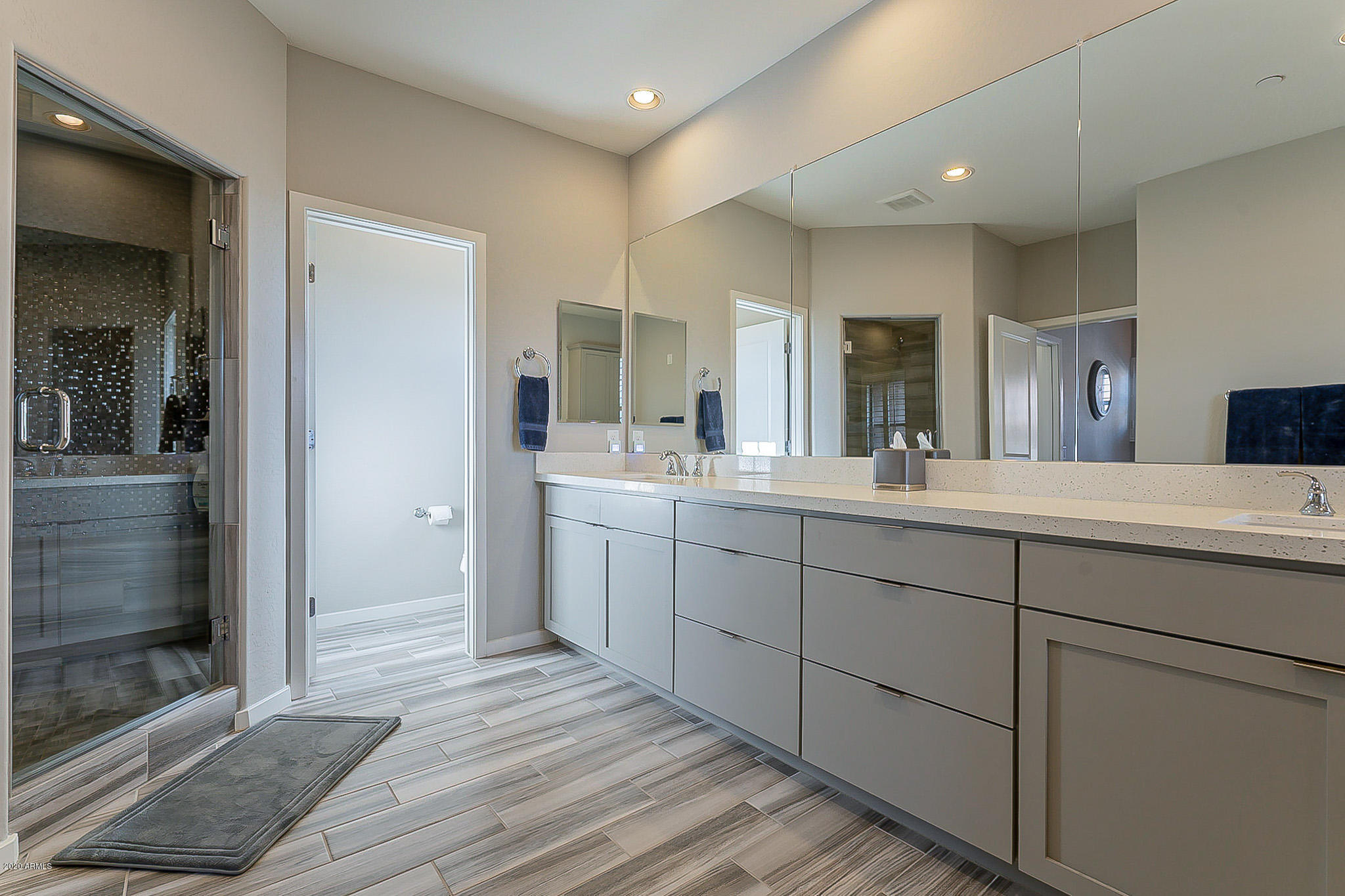 3935 East Rough Rider Road, Unit 1337 Phoenix, AZ 85050 - Photo 42 of 57 a spacious bathroom with a double vanity sink and a mirror
