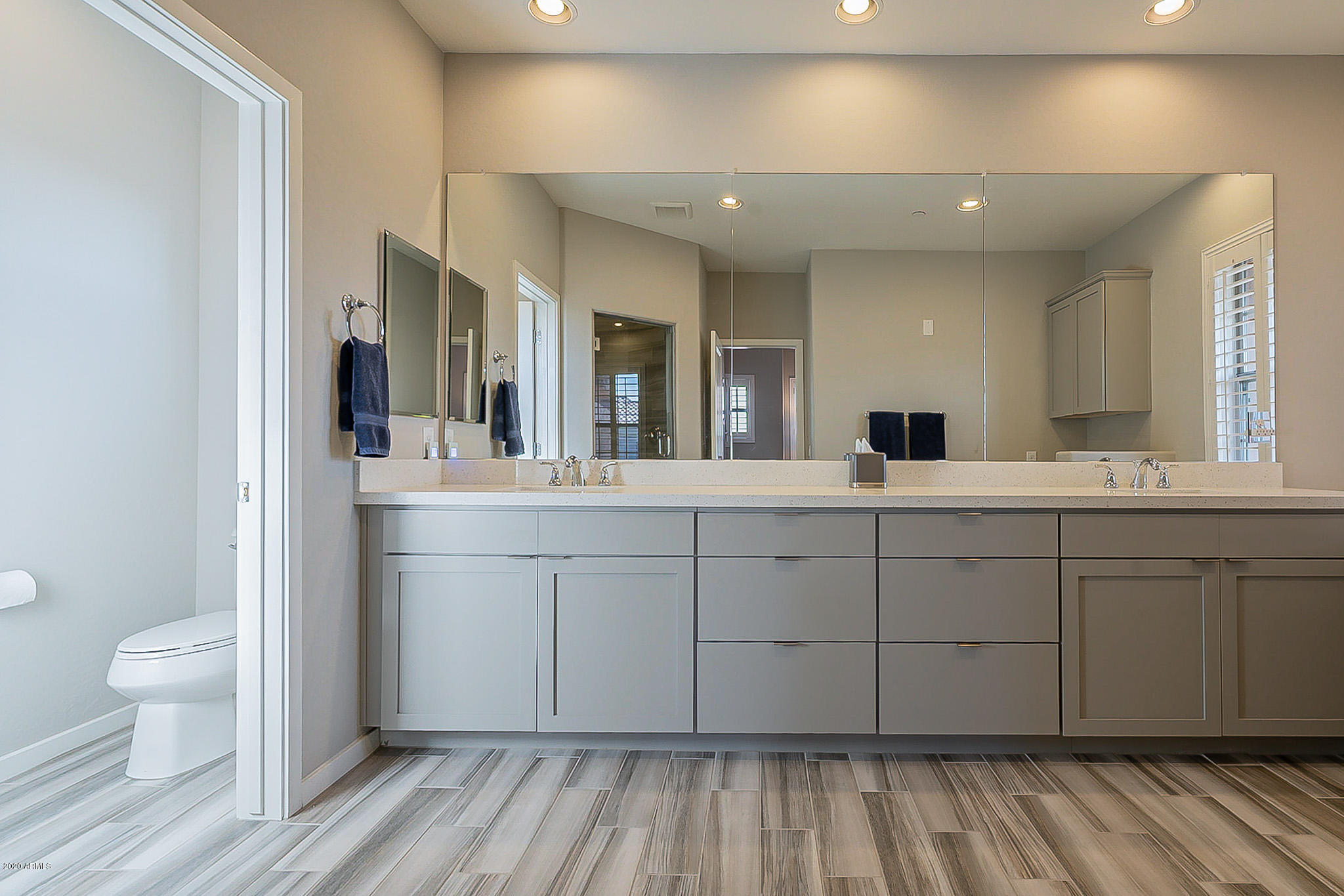 3935 East Rough Rider Road, Unit 1337 Phoenix, AZ 85050 - Photo 43 of 57 a spacious bathroom with a double vanity sink and a mirror