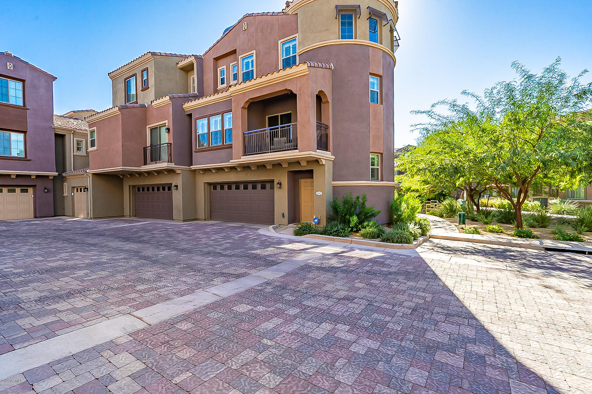 3935 East Rough Rider Road, Unit 1337 Phoenix, AZ 85050 - Photo 49 of 57 a front view of a building with a yard and parking