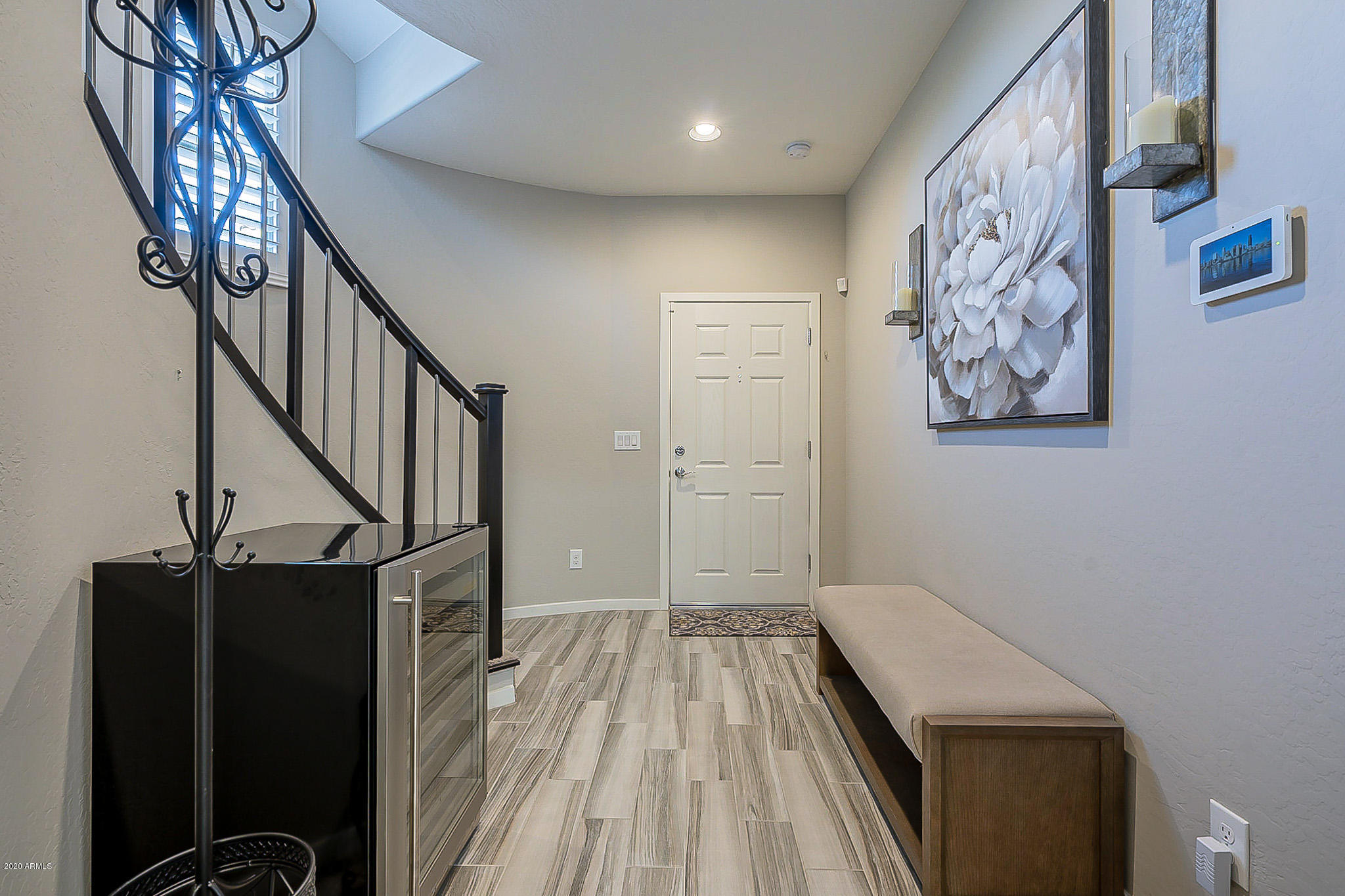 3935 East Rough Rider Road, Unit 1337 Phoenix, AZ 85050 - Photo 6 of 57 a view of a hallway with wooden floor and staircase