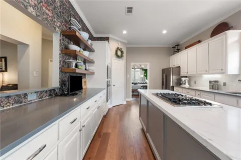 a large kitchen with stainless steel appliances granite countertop a stove and a sink