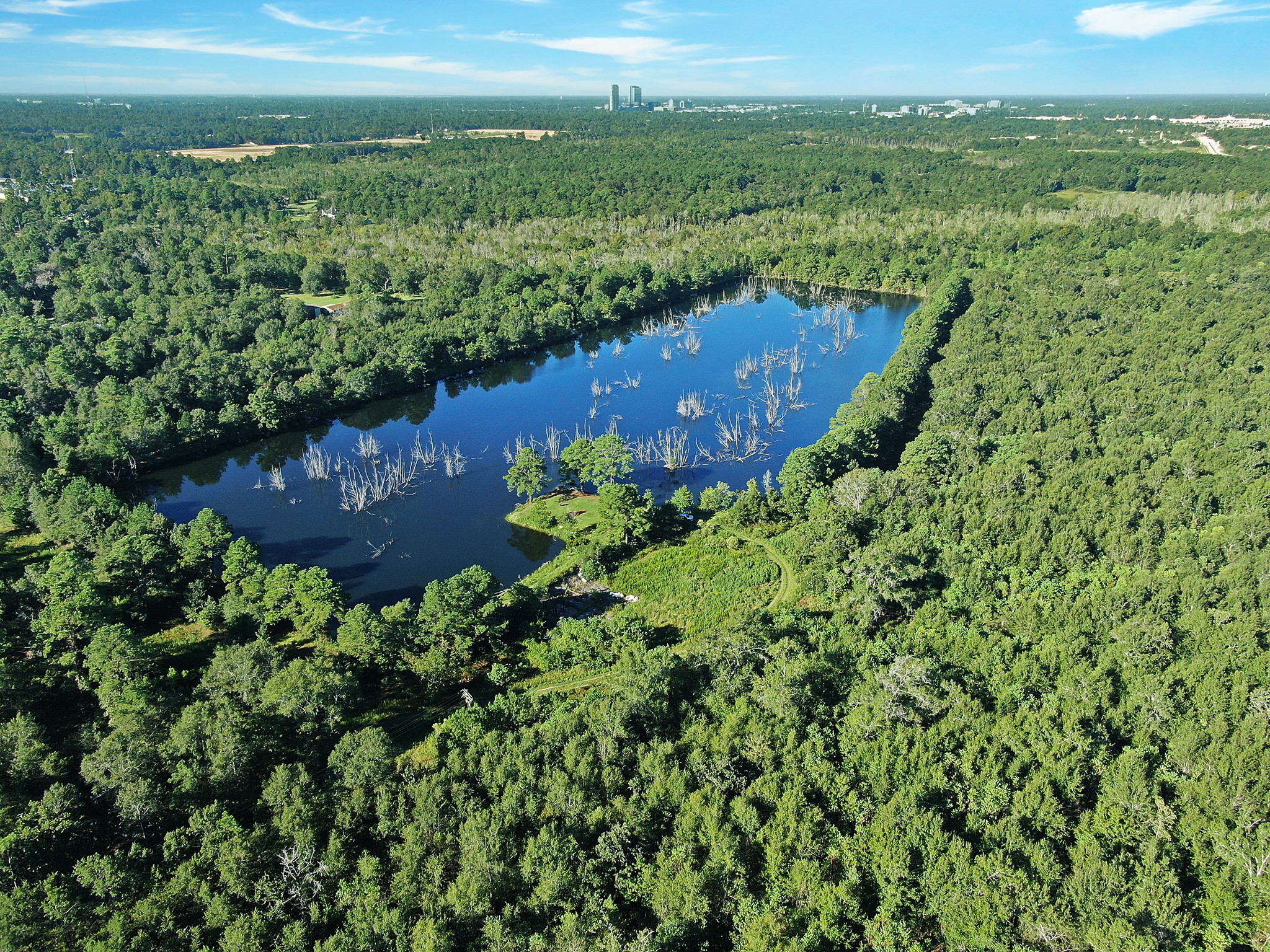 This quiet heavily wooded property is filled with rolling hills and beautiful terrain. You will never even know are so close to the city. Beautiful 20 acre lake is the perfect fishing spot.