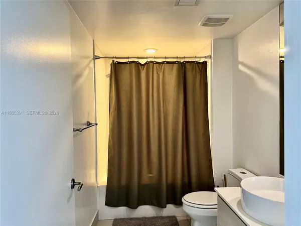 a bathroom with a toilet and shower