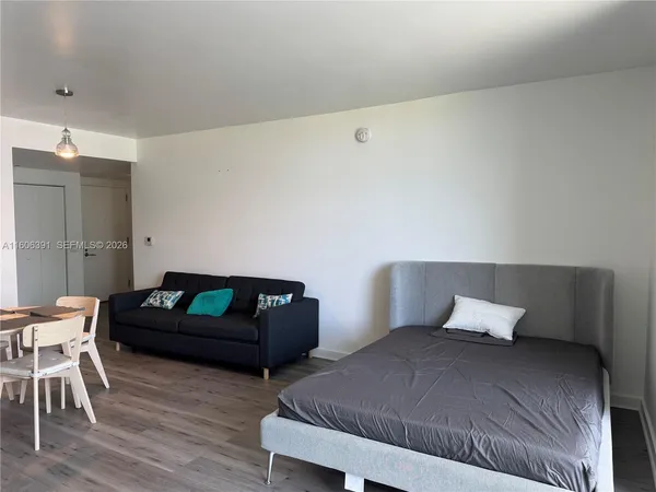 a bedroom with a bed and a chair