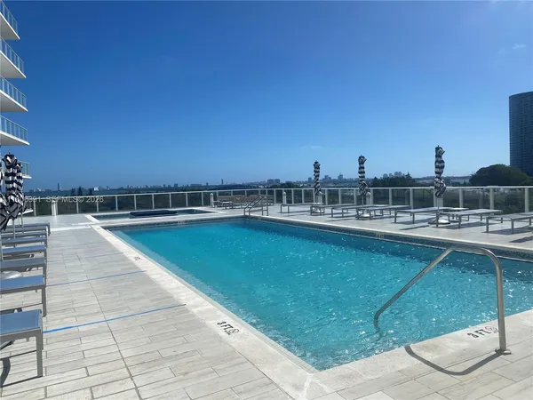 a view of swimming pool with outdoor seating and city view