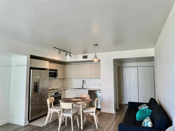 a kitchen with stainless steel appliances kitchen island granite countertop a sink and cabinets