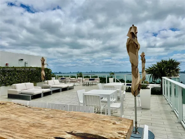 a roof deck with a table and chairs