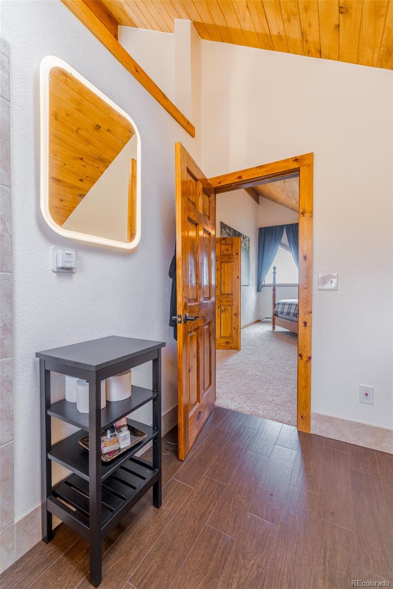 8221 Remington Road Como, CO 80432 - Photo 31 of 49 a view of a hallway with wooden floor and a cabinet