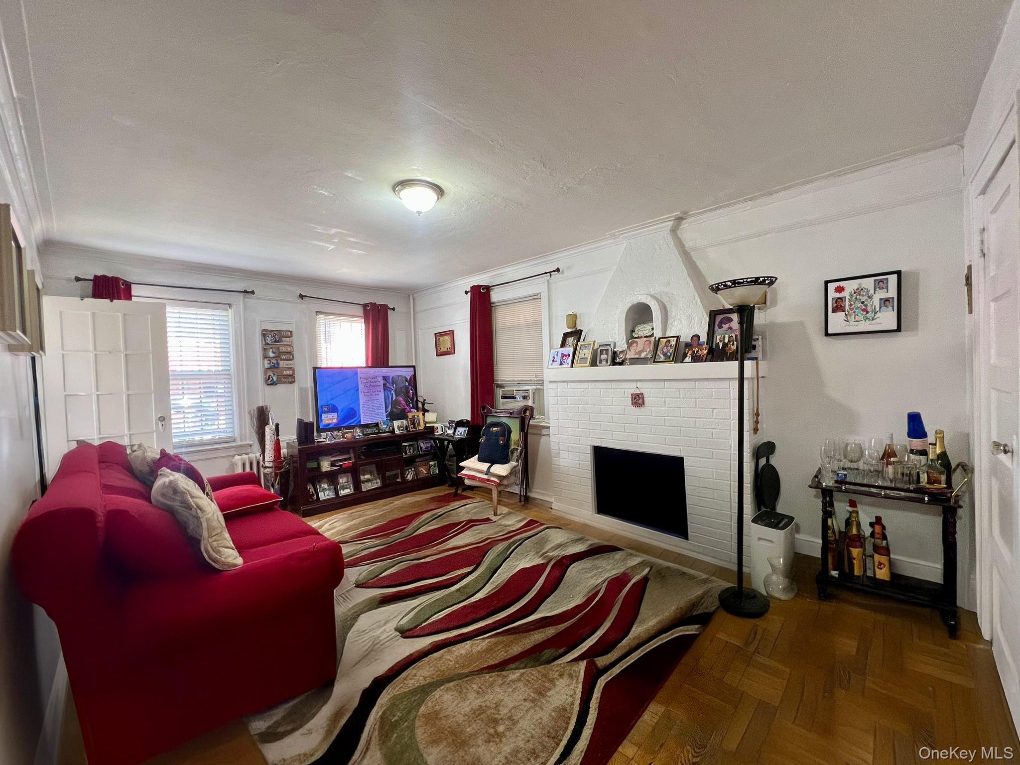 102-56 46th Avenue Queens, NY 11368 - Photo 2 of 14 a living room with furniture and a fireplace