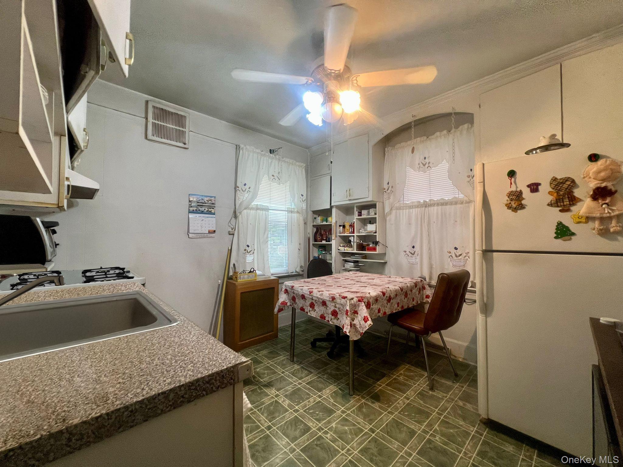 102-56 46th Avenue Queens, NY 11368 - Photo 10 of 14 a kitchen with stainless steel appliances granite countertop sink refrigerator and microwave