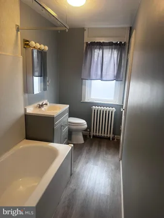 a bathroom with a sink toilet and mirror
