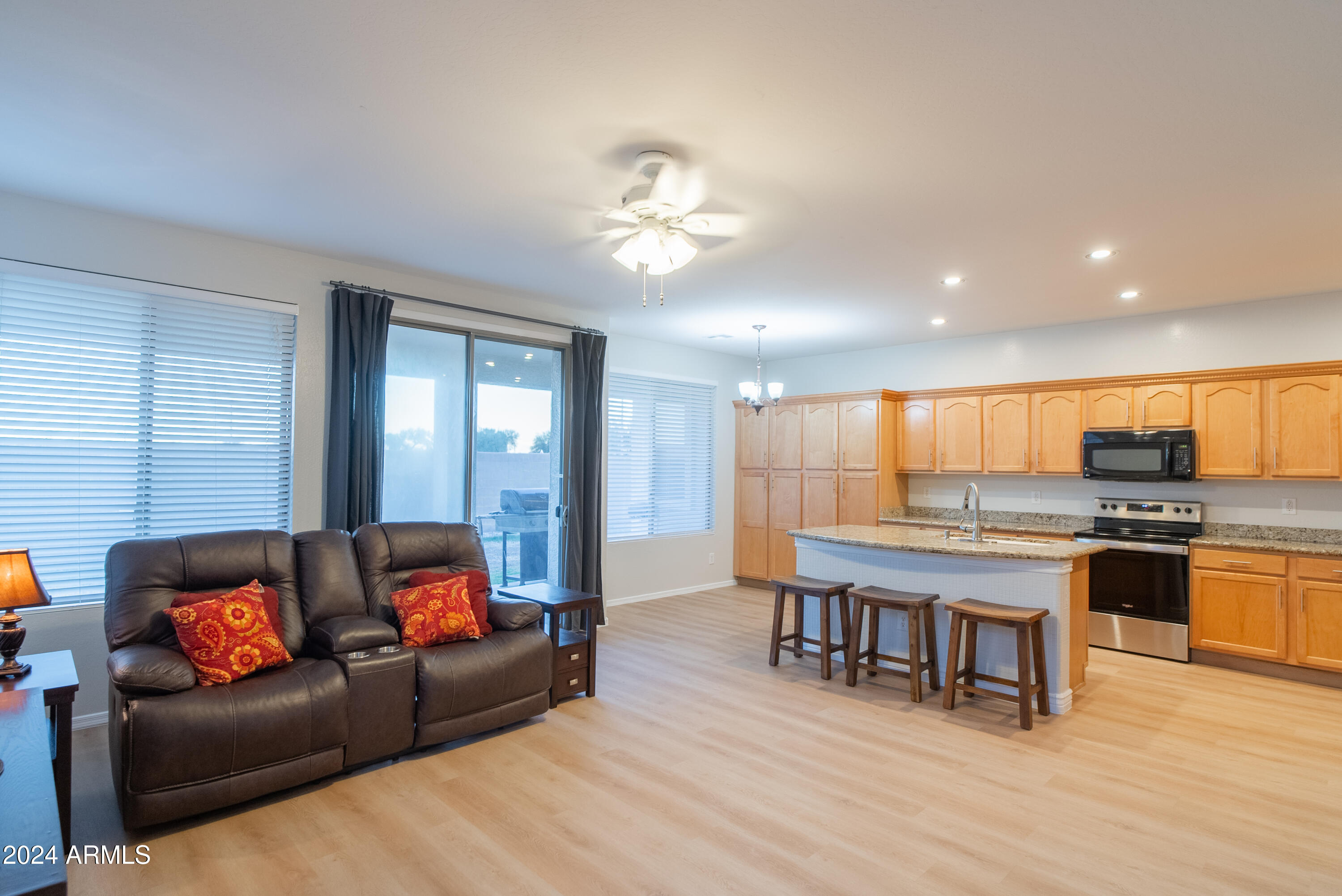 15471 West Statler Circle Surprise, AZ 85374 - Photo 14 of 32 a living room with stainless steel appliances kitchen island granite countertop furniture and a kitchen view