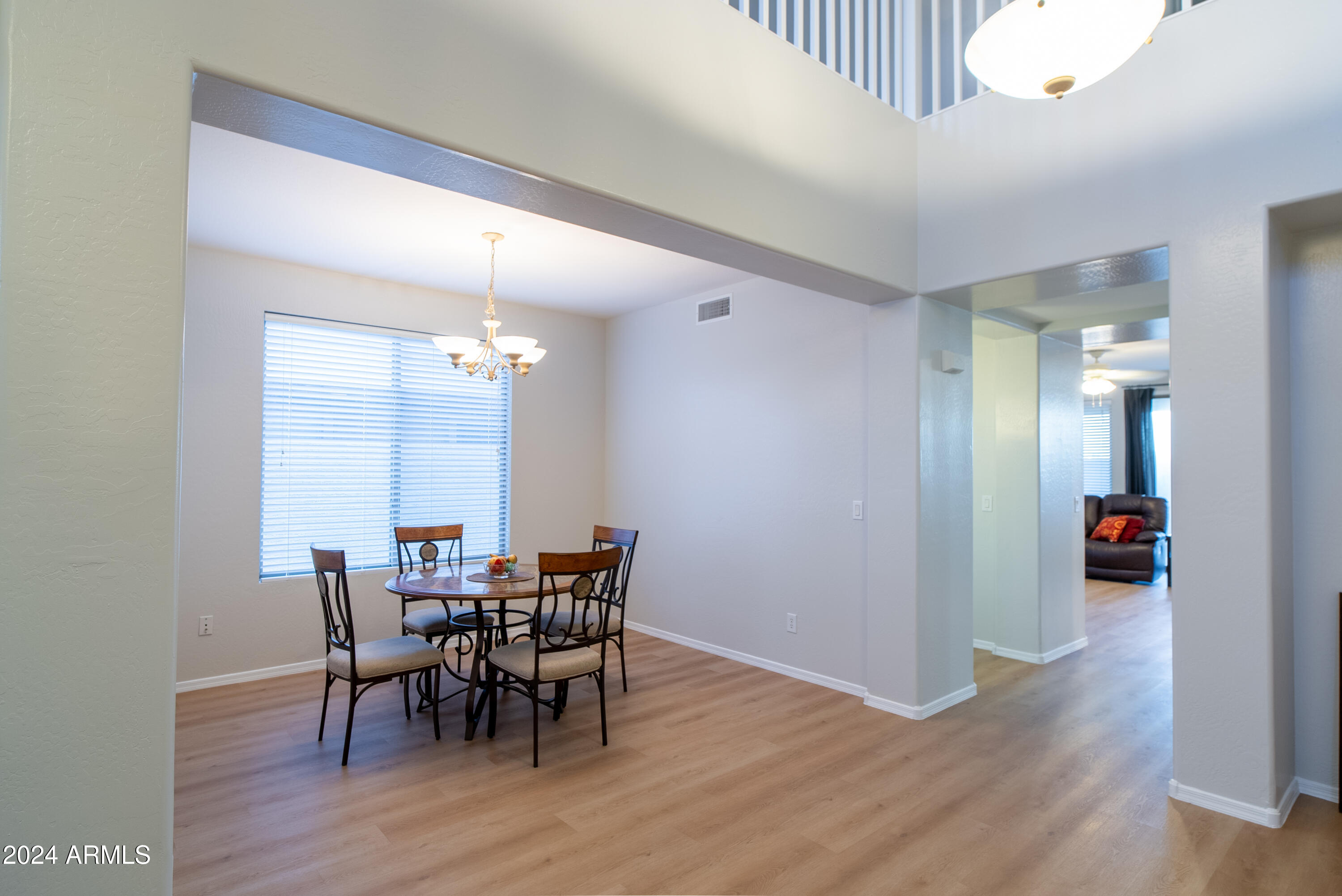 15471 West Statler Circle Surprise, AZ 85374 - Photo 9 of 32 a view of a dining room with furniture and wooden floor