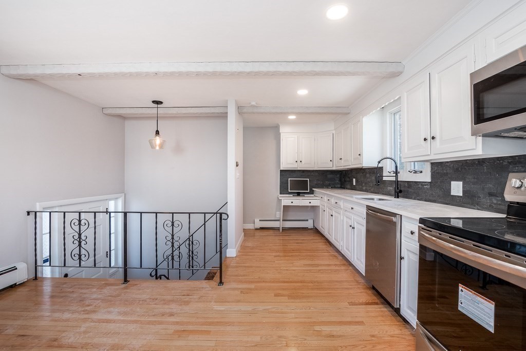 570 Canton Street Stoughton, MA 02072 - Photo 11 of 41 a large kitchen with stainless steel appliances granite countertop a stove a sink and a microwave