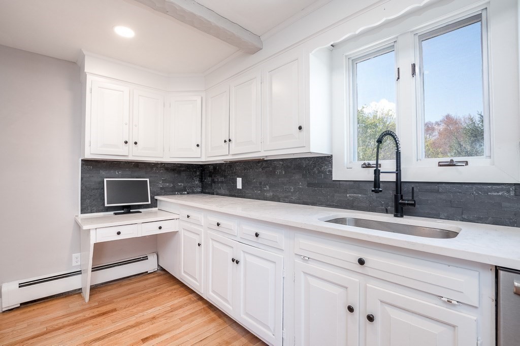 570 Canton Street Stoughton, MA 02072 - Photo 12 of 41 a kitchen with granite countertop white cabinets and white appliances