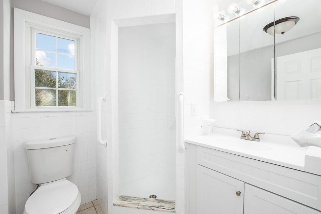 570 Canton Street Stoughton, MA 02072 - Photo 24 of 41 a bathroom with a sink a toilet and a mirror