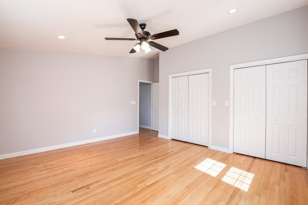 570 Canton Street Stoughton, MA 02072 - Photo 25 of 41 a view of an empty room with wooden floor and a ceiling fan