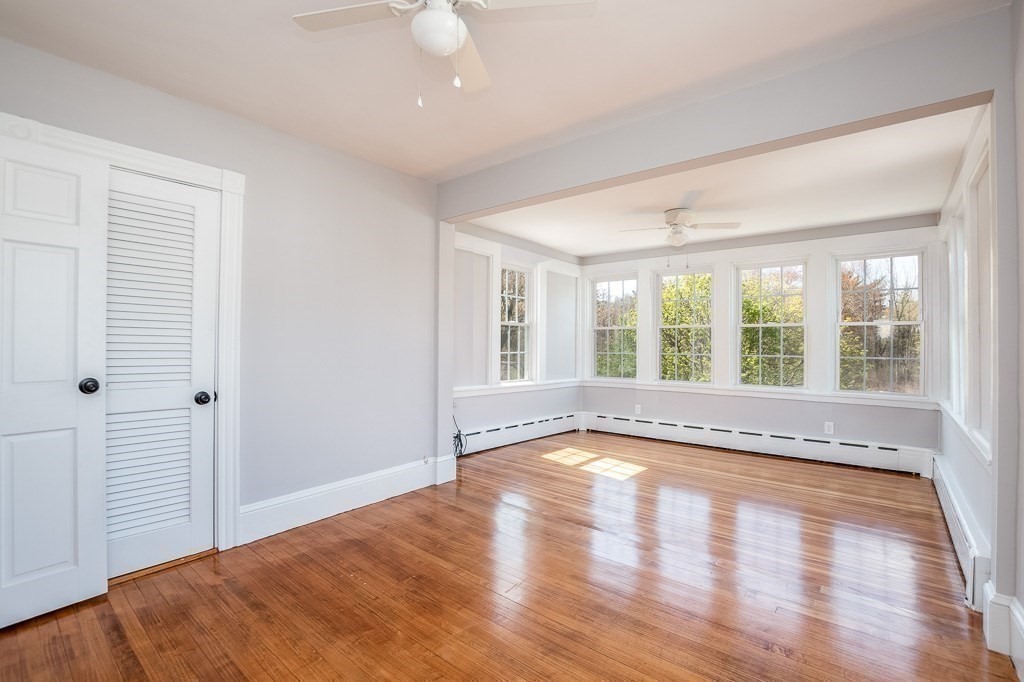 570 Canton Street Stoughton, MA 02072 - Photo 28 of 41 a view of an empty room with wooden floor and a window