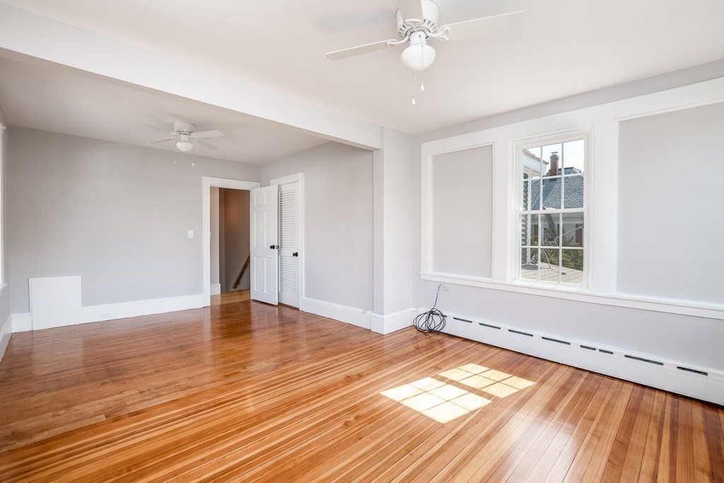 570 Canton Street Stoughton, MA 02072 - Photo 30 of 41 a view of an empty room with wooden floor and a window