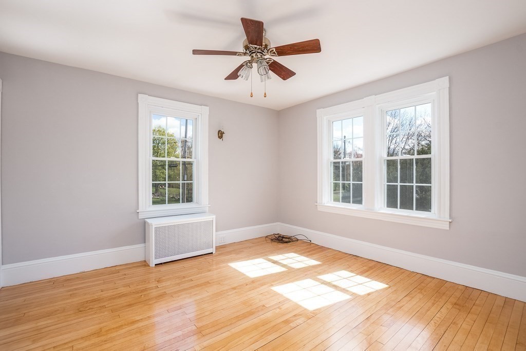 570 Canton Street Stoughton, MA 02072 - Photo 31 of 41 a view of an empty room with a window and wooden floor