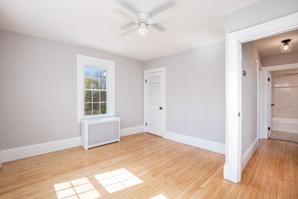 570 Canton Street Stoughton, MA 02072 - Photo 33 of 41 an empty room with wooden floor and windows