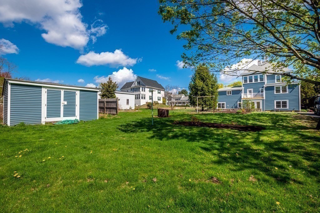 570 Canton Street Stoughton, MA 02072 - Photo 5 of 41 a view of a house with a big yard and large trees