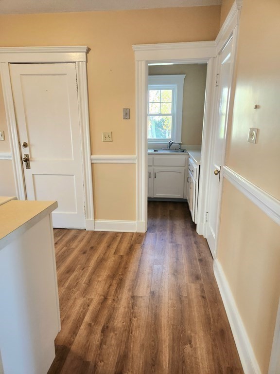 25 Glendower Road, Unit 2 Boston, MA 02131 - Photo 7 of 17 a view of a hallway with wooden floor and a living room