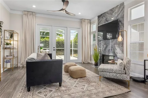 a living room with furniture and a floor to ceiling window