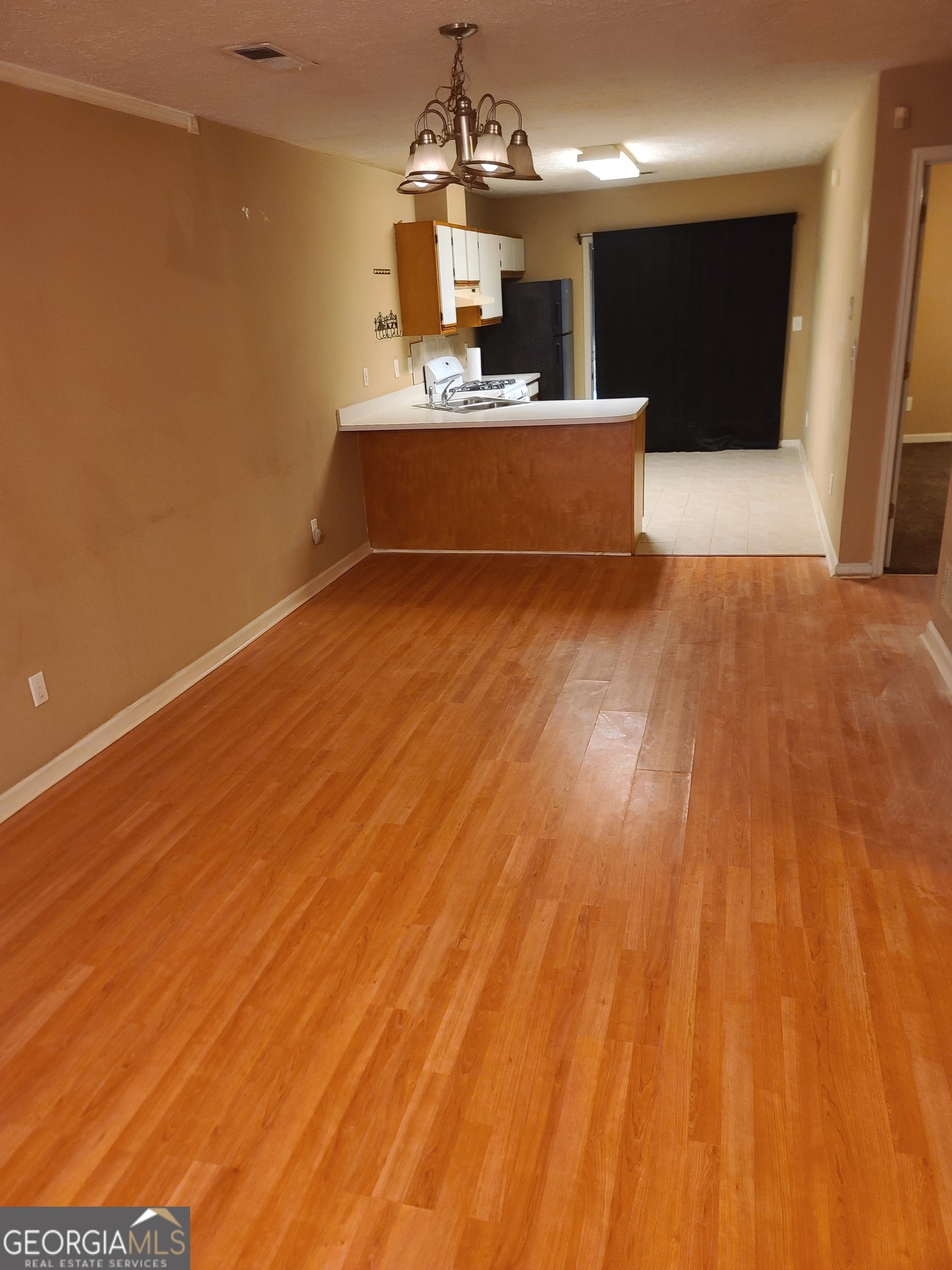 807 Boston Common Atlanta, GA 30349 - Photo 4 of 9 a view of a room with wooden floor and a window