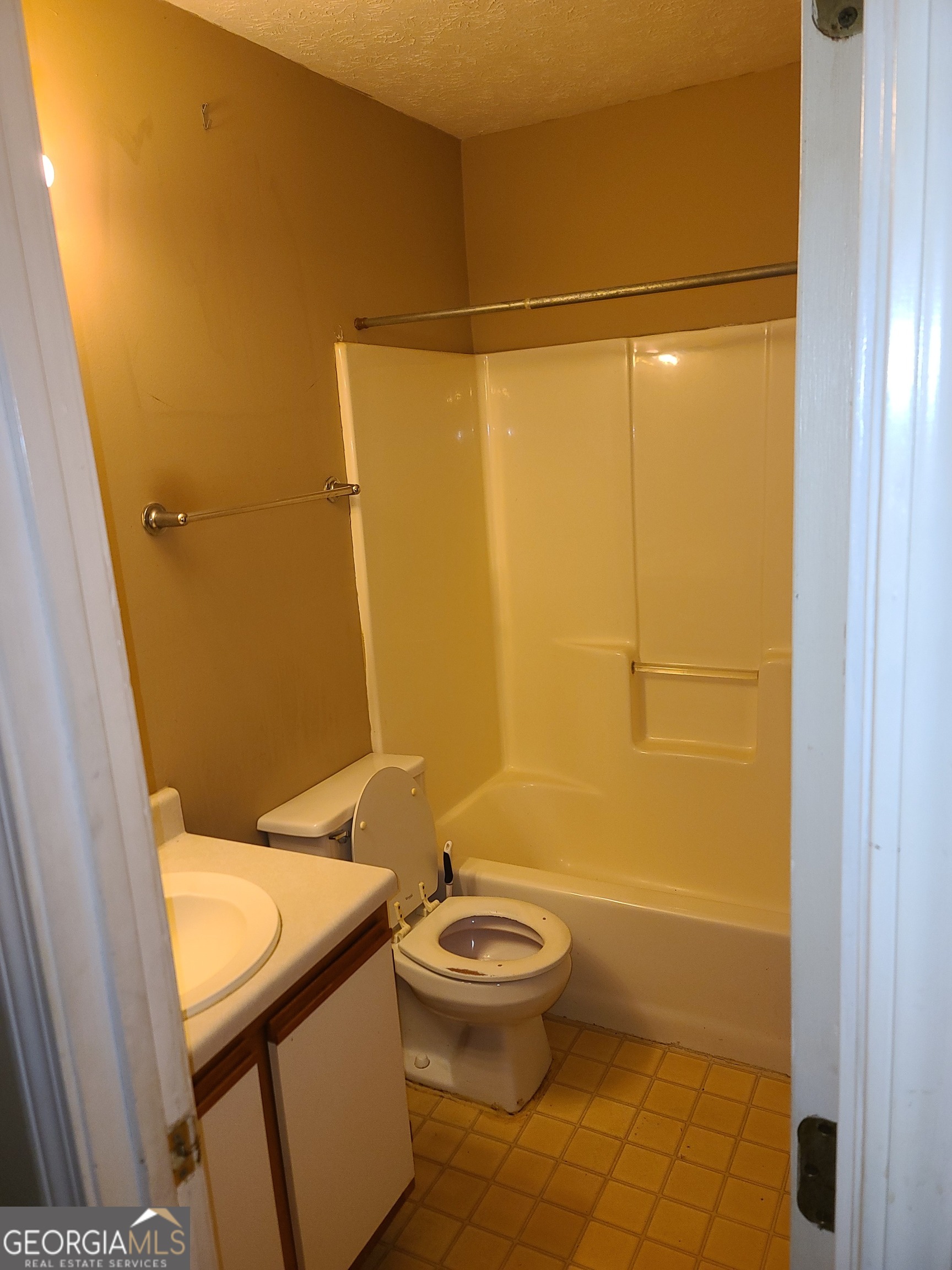 807 Boston Common Atlanta, GA 30349 - Photo 9 of 9 a bathroom with a granite countertop sink toilet and shower