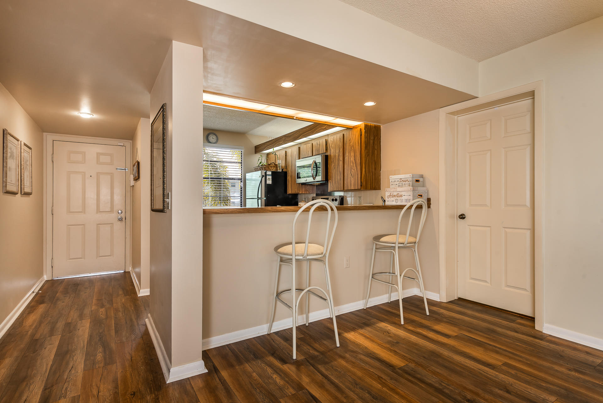 6109 Balboa Circle, Unit 206 Boca Raton, FL 33433 - Photo 12 of 18 a view of a kitchen with wooden floor and chairs