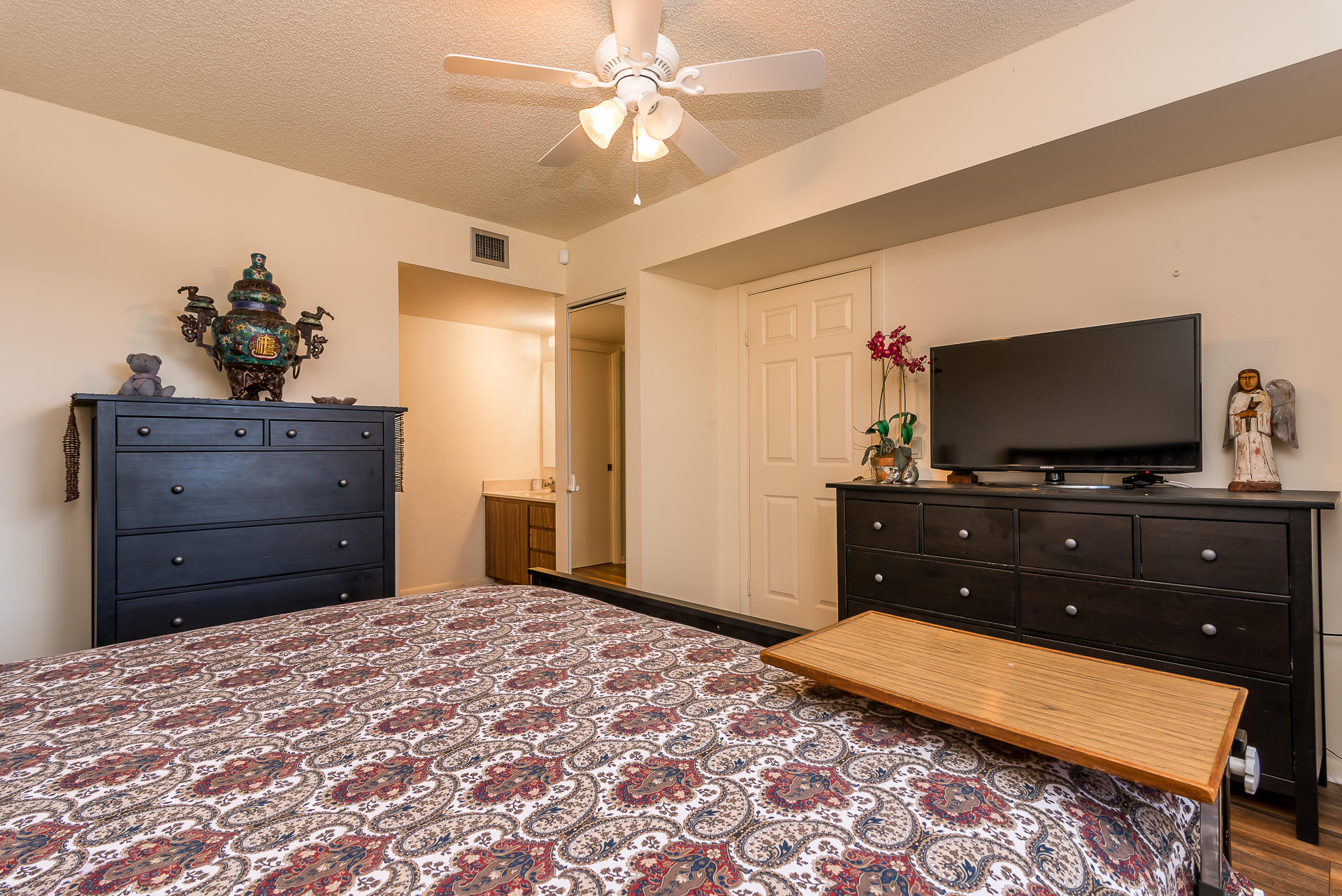 6109 Balboa Circle, Unit 206 Boca Raton, FL 33433 - Photo 14 of 18 a bedroom with a bed and a flat screen tv