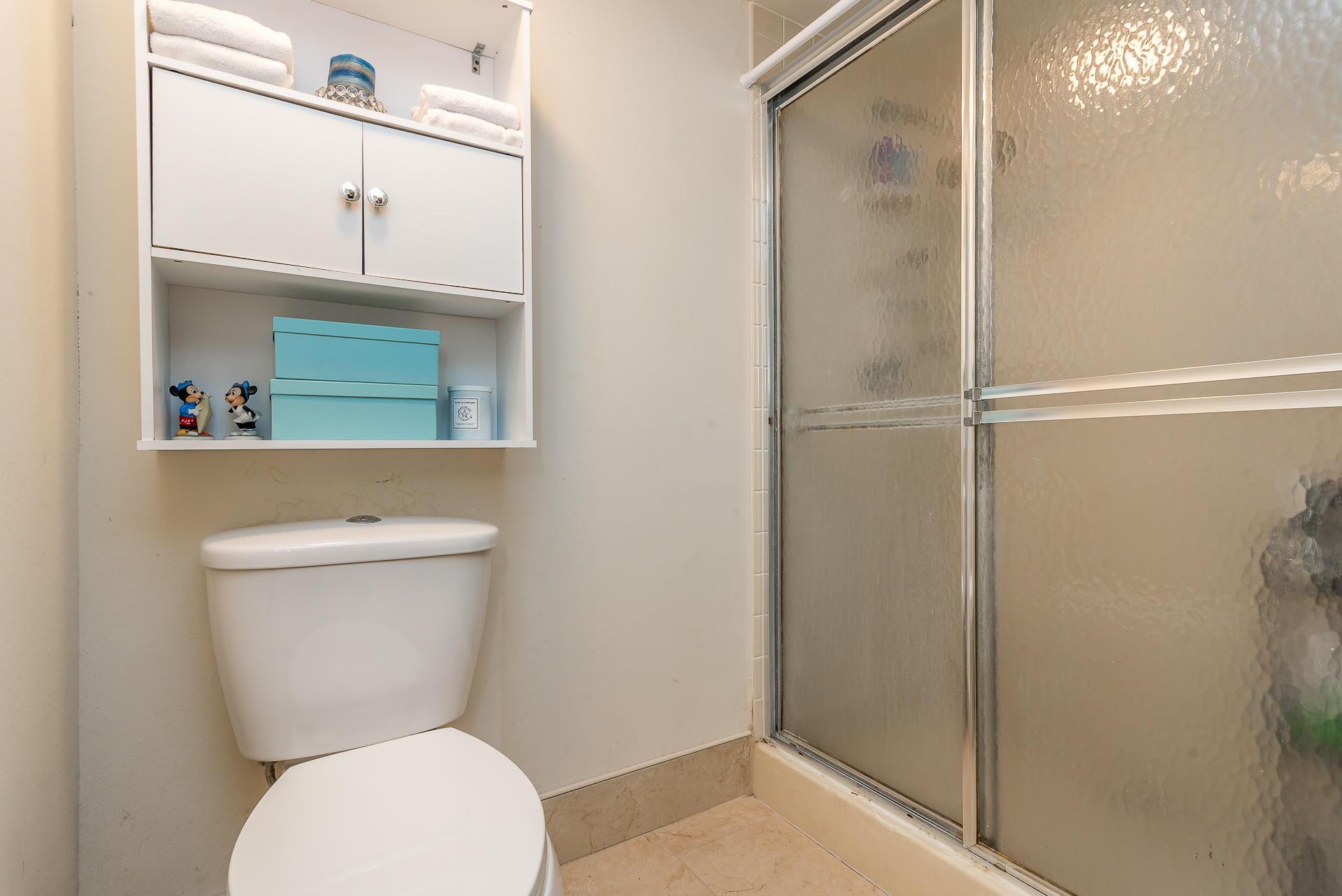 6109 Balboa Circle, Unit 206 Boca Raton, FL 33433 - Photo 15 of 18 a bathroom with a toilet a sink and a mirror