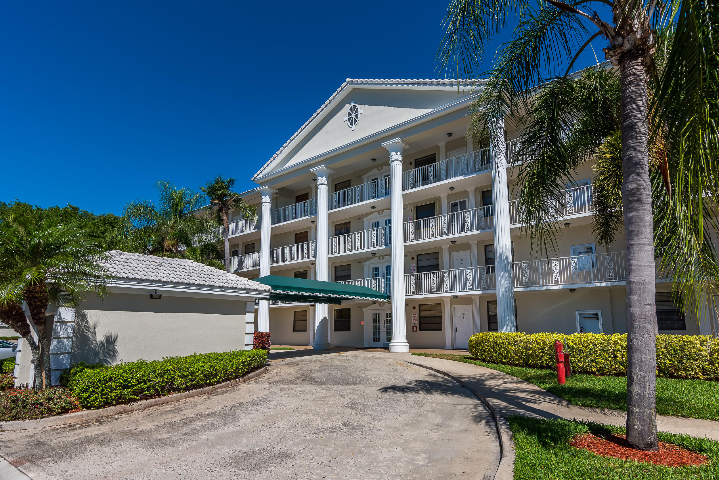 6109 Balboa Circle, Unit 206 Boca Raton, FL 33433 - Photo 2 of 18 a front view of a house with a garden