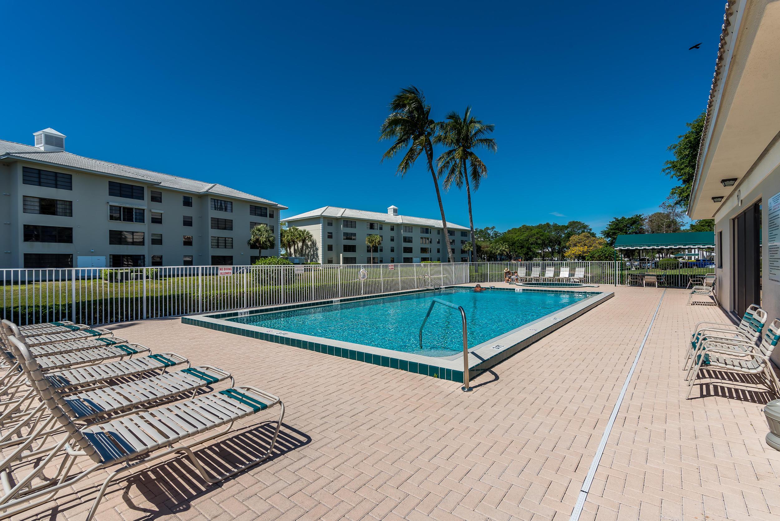 6109 Balboa Circle, Unit 206 Boca Raton, FL 33433 - Photo 3 of 18 a view of a swimming pool with a patio