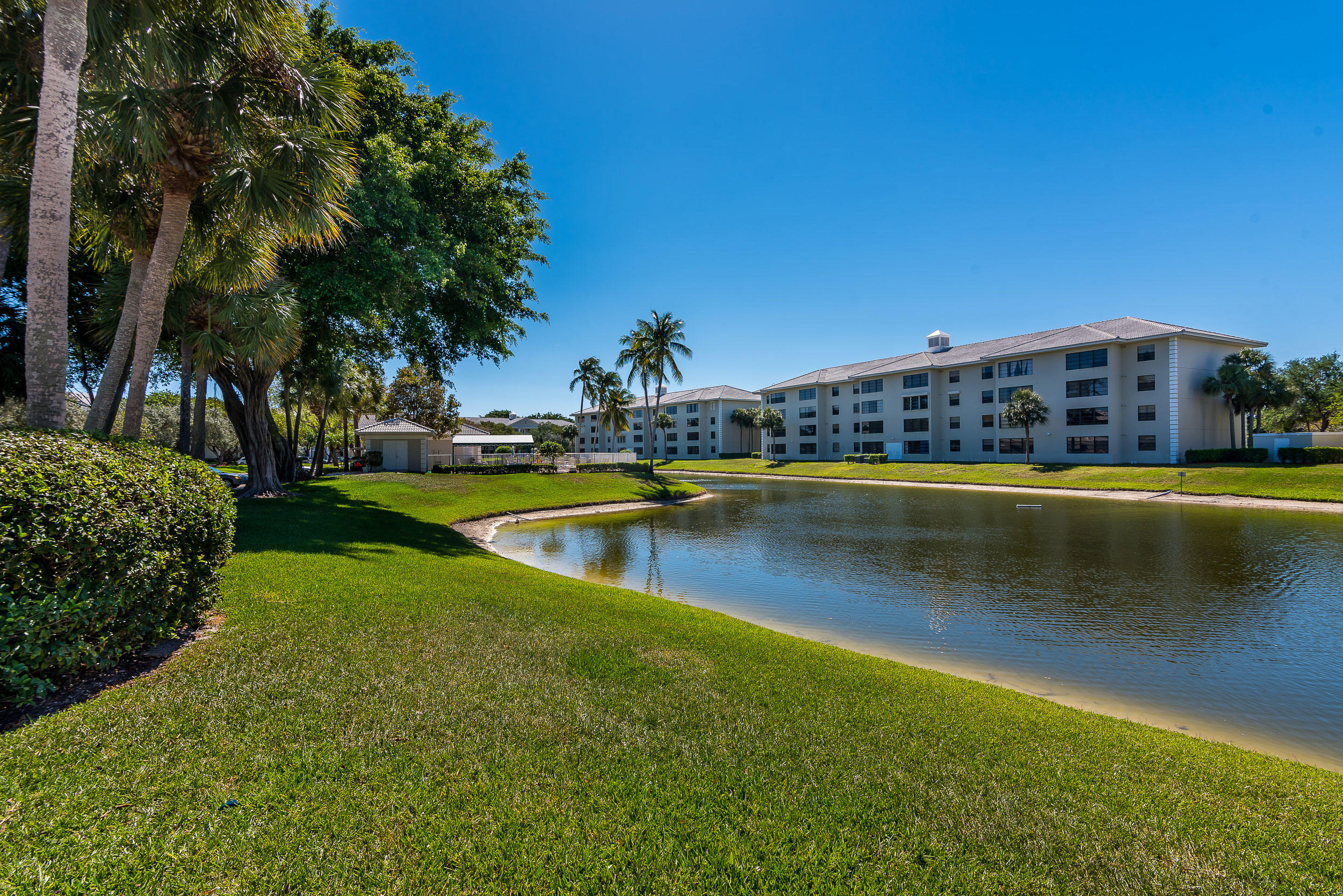 6109 Balboa Circle, Unit 206 Boca Raton, FL 33433 - Photo 5 of 18 a view of a swimming pool with an outdoor seating and yard