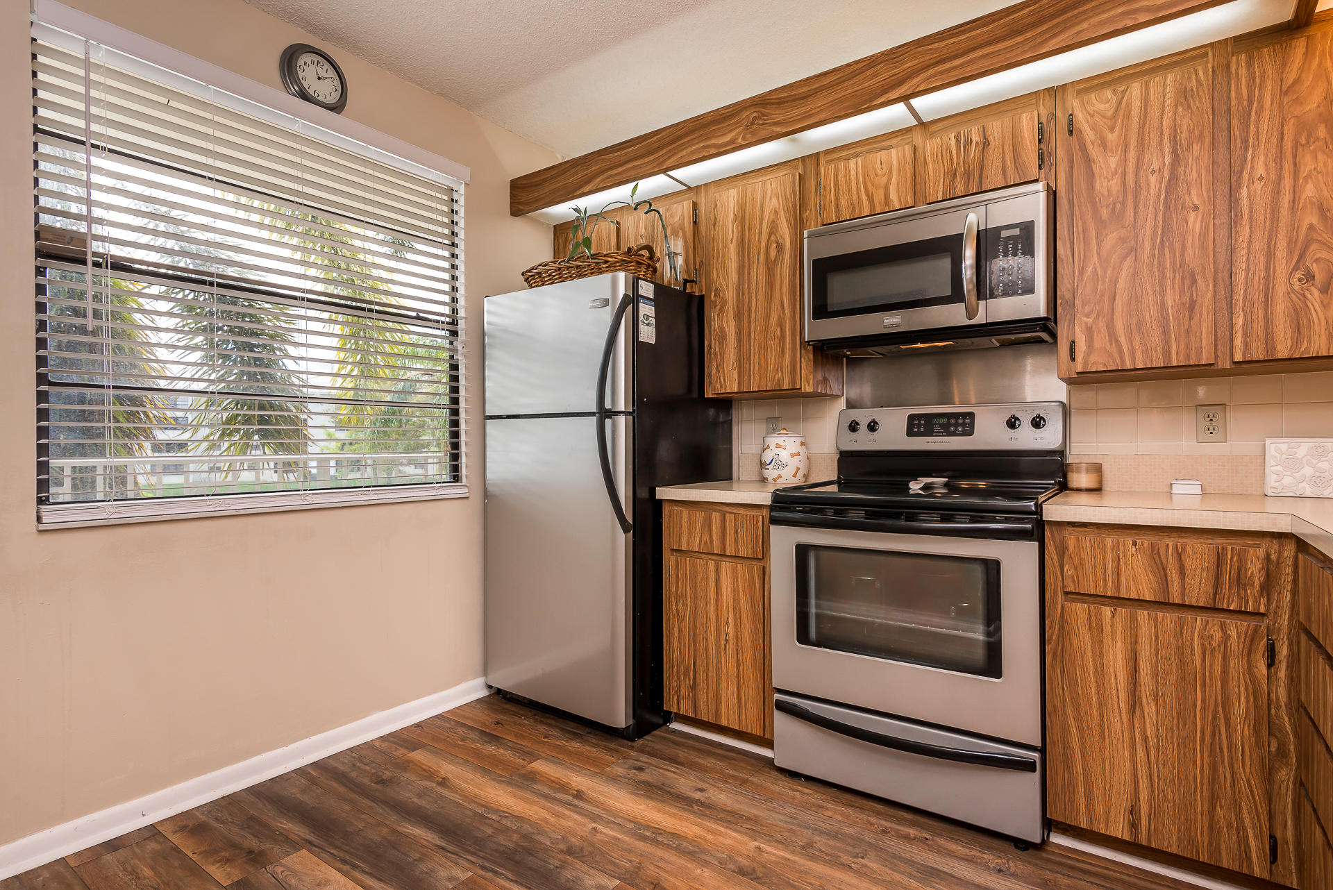 6109 Balboa Circle, Unit 206 Boca Raton, FL 33433 - Photo 8 of 18 a kitchen with a stove microwave and refrigerator