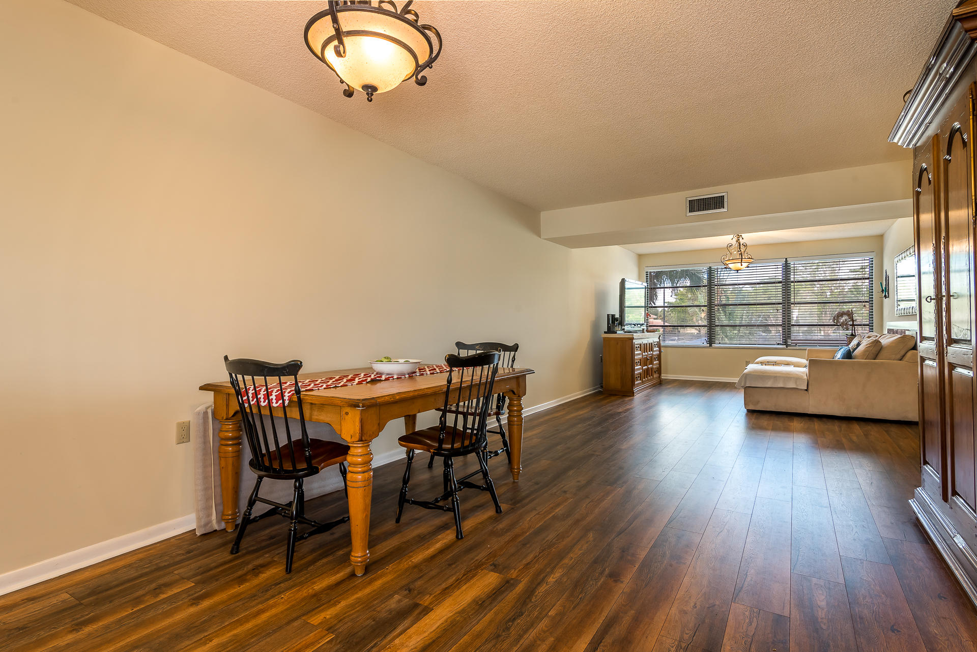 6109 Balboa Circle, Unit 206 Boca Raton, FL 33433 - Photo 9 of 18 a view of a dining room with furniture and wooden floor