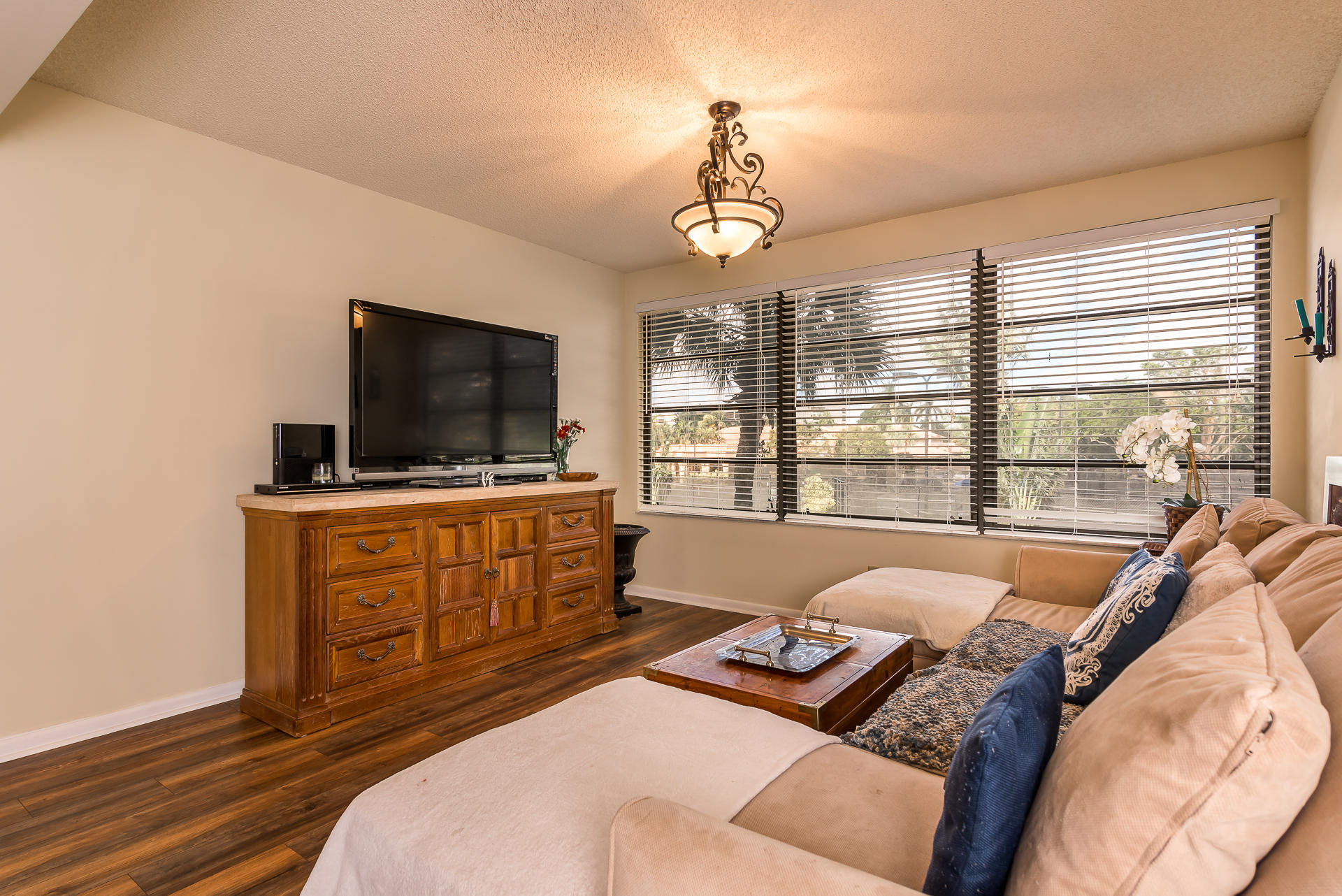 6109 Balboa Circle, Unit 206 Boca Raton, FL 33433 - Photo 10 of 18 a bedroom with furniture and a flat screen tv