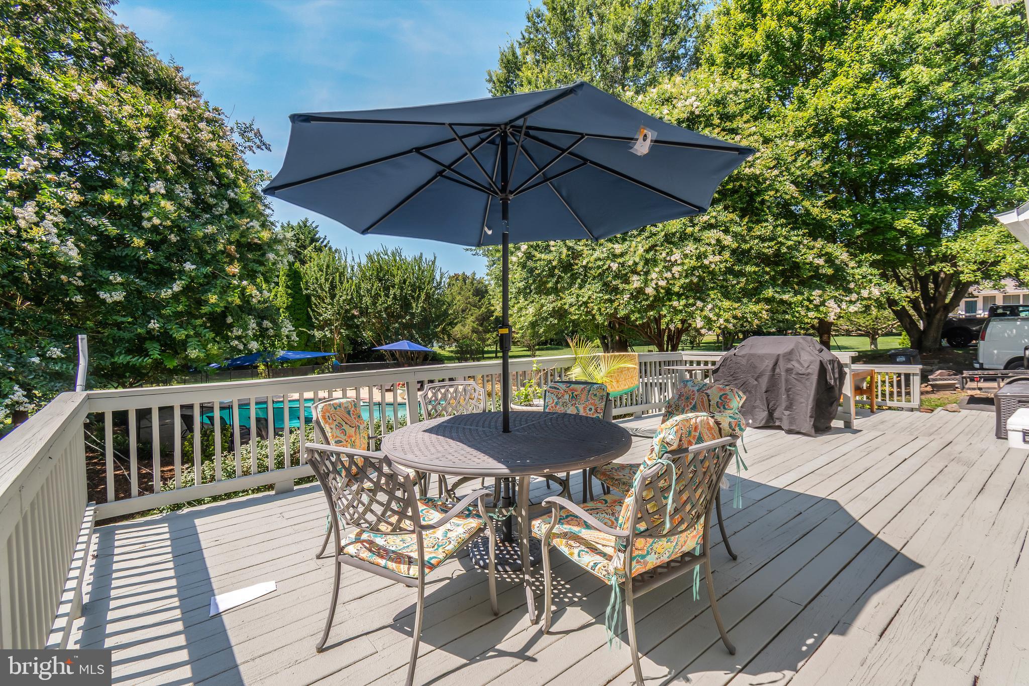 3040 Jones Road Dunkirk, MD 20754 - Photo 14 of 67 a patio with wooden floor a yard a table and chairs